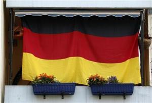 A German national flag hangs on a house in Dortmund June 19, 2012. REUTERS/Ina Fassbender