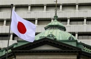 A Japanese flag flies atop the Bank of Japan building in Tokyo September 26, 2012. REUTERS/Yuriko Nakao